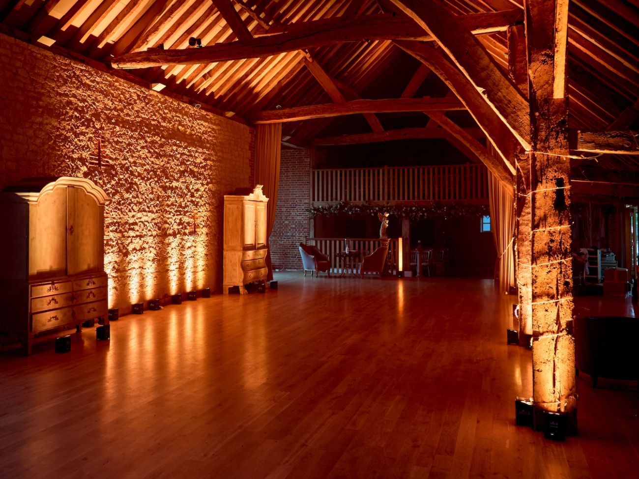 Bury Court Barn in Hampshire with amber colour lighting - Live Wedding Band | wedding band | live music band for wedding | band live wedding | wedding live band price | AKA Party Band