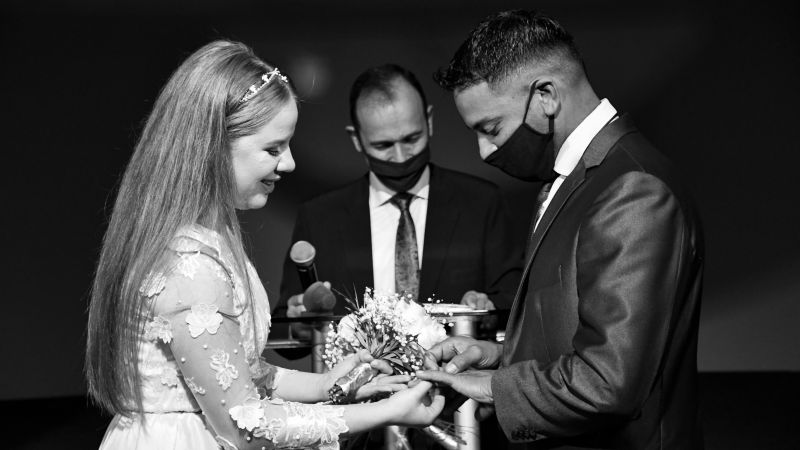 Covid bride and groom at the alter sharing rings before parting away with the live band in the evening - Live Wedding Band | Surrey wedding entertainment | live band for wedding | Live band for wedding reception | AKA Party Band