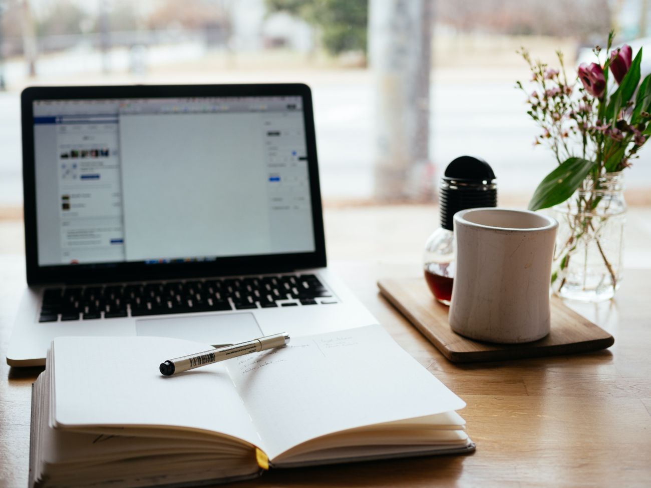Notepad, pen and computer designing your wedding website - Live Wedding Band | Hampshire wedding band | wedding music live band | best live wedding bands | how much does a live band cost for a wedding | AKA Party Band