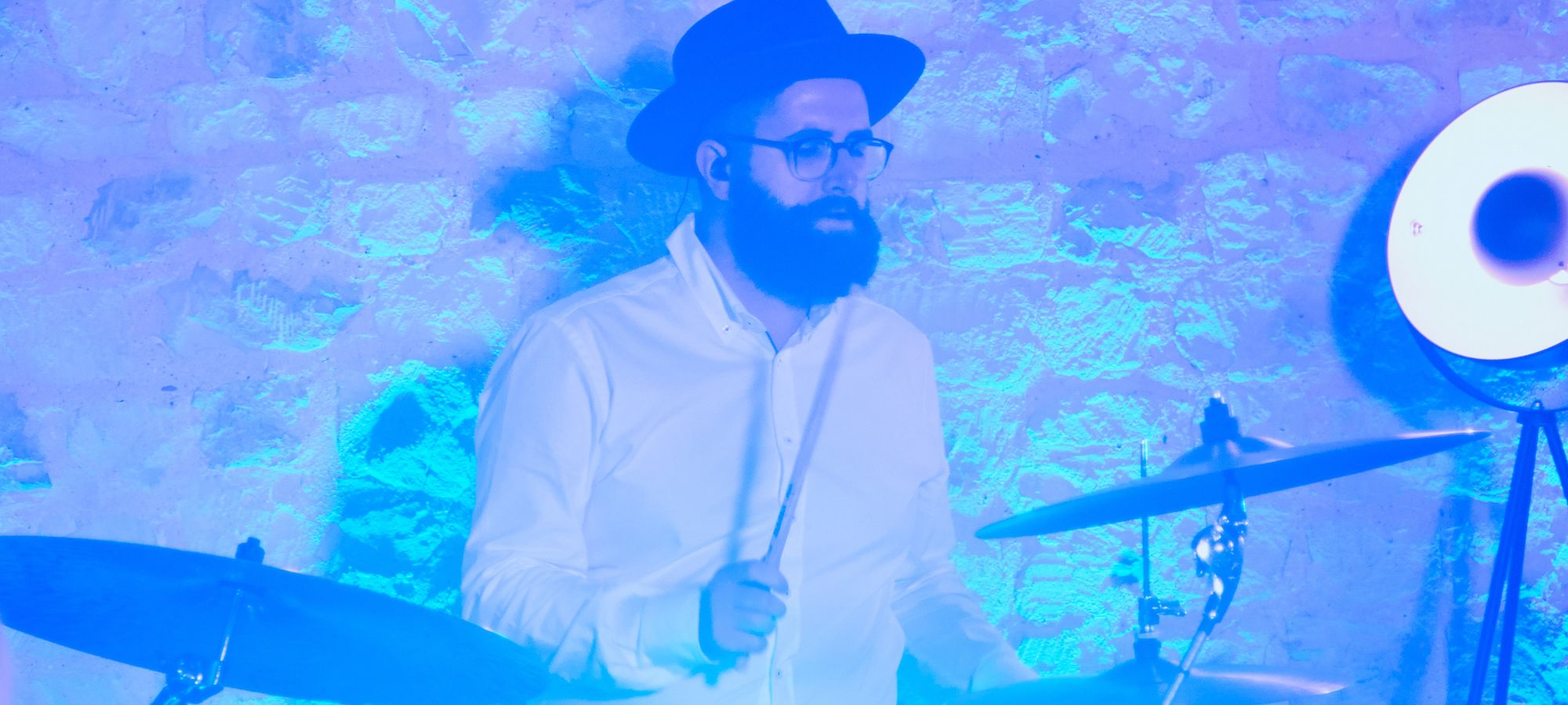 AKA drummer with blue party lighting at Bury Court Barn in Hampshire - Live Wedding Band | hampshire wedding bands | wedding live band cost | live bands for weddings in Kent | AKA Party Band